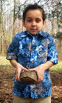Photo of boy holding turtle